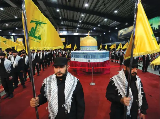  ?? (Reuters) ?? HEZBOLLAH MEMBERS stand in front of a replica of the Dome of the Rock during a rally marking Al-Quds day recently in Beirut.