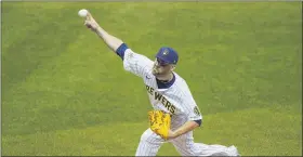  ?? MORRY GASH — THE ASSOCIATED PRESS ?? Milwaukee Brewers relief pitcher David Phelps throws during the seventh inning of a baseball game against the Pittsburgh Pirates Friday.