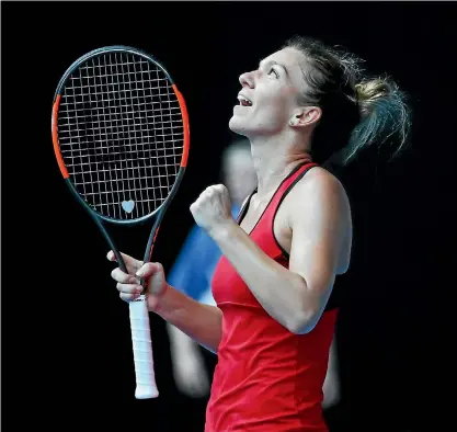  ?? CLIVE BRUNSKILL/GETTY IMAGES ?? Simona Halep looks to the heavens after clinching match point in her gruelling semifinal against Angelique Kerber.