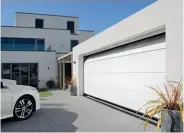  ??  ?? Above: Garador’s Linear Large sectional garage door with full insulation in Traffic White is priced from £1,184. Below: This Border Oak garage offers shelter for cars and an additional storage space