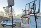  ?? AUBREY ROBINSON ?? FedEx driver Aubrey Robinson had a special gift for young Eli Maines at his home outside West Harrison, Indiana: a new basketball hoop and backboard.