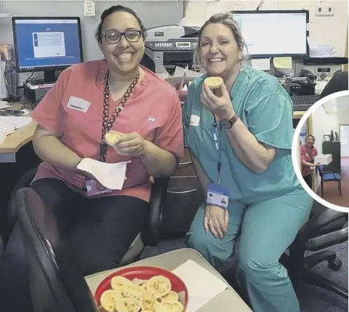  ??  ?? TUCKING IN: Calderdale Royal Hospital Staff enjoy some sweet treats baked by Fountain Head estate residents.