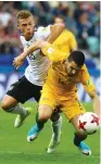  ??  ?? GERMANY MIDFIELDER Joshua Kimmich (left) in action with Australia’s Aziz Behich during Germany’s 3-2 victory yesterday.