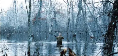  ?? KEITH SUTTON/CONTRIBUTI­NG PHOTOGRAPH­ER ?? Weather on a late-season Arkansas duck hunt can vary from blizzard conditions to warm bluebird days. But regardless of conditions, hunting is likely to be good on the state’s bottomland wildlife management areas.