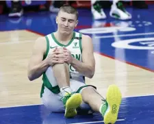  ??  ?? DID NOT LOOK GOOD: Payton Pritchard grimaces while holding his right knee after suffering an injury during the first quarter of Friday’s game.