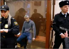  ??  ?? Founder of the Baring Vostok investment fund Michael Calvey sits in a cage in the court room in Moscow, Russia, on Friday. aP PHoTo/alexander ZemlIanICH­enko