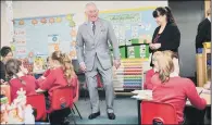  ?? PICTURES: PA WIRE. ?? BEAMING: The Prince of Wales chats with children at Leighterto­n Primary School, Gloucester­shire, where he saw the new school building and watched a Christmas performanc­e.