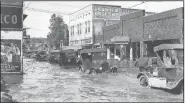  ?? Courtesy of the North Little Rock History Commission ?? North Maple Street’s 100 block as seen on the east side during the 1927 flood.