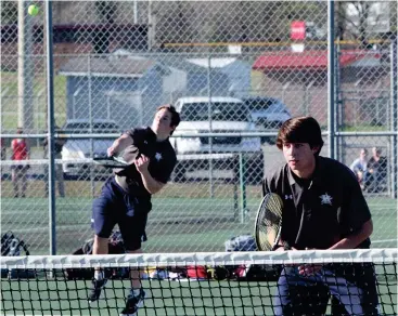  ??  ?? Heritage’s Ethan Bone serves during a match at Ridgeland last week, while doubles partner Blake Richardson awaits a return. (Catoosa County News file photo/Scott Herpst)