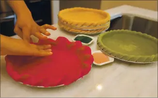  ??  ?? Pietisseri­e baker Jaynelle St. Jean molds the dough for one of her new vividly hued monochroma­tic pies.