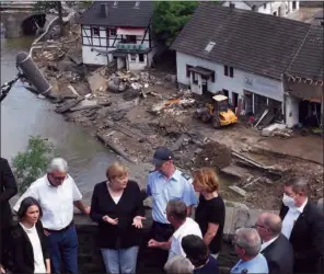  ?? (AFP) ?? German Chancellor Angela Merkel (centre-left) in Schuld near Bad Neuenahr-Ahrweiler, Rhineland-Palatinate state, western Germany, on Sunday.