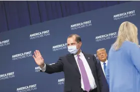  ?? Brendan Smialowski / AFP via Getty Images ?? Secretary of Health and Human Services Alex Azar waves as President Trump leaves after signing an executive order on health care in Charlotte, N.C.