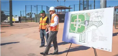  ?? PHOTOS BY CHARLIE LEIGHT/THE REPUBLIC ?? Constructi­on crew members tour newly renovated facilities this week as Fitch Park (above) and Hohokam Stadium (below) undergo major upgrades ahead of the Oakland Athletics’ arrival this coming spring.