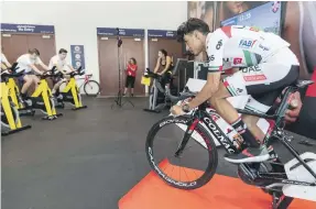  ?? Antonie Robertson / The National ?? Yousif Mirza, right, takes a cycling class after launching the UAE Team Emirates Youth Academy at the Dubai Sports World at World Trade Center
