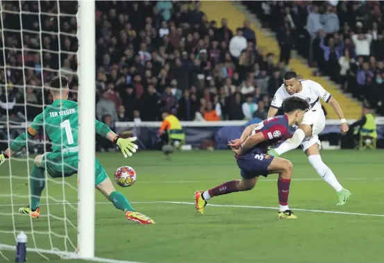  ?? GETTY IMAGES ?? Kylian Mbappe, of Paris Saint-Germain, scores his team’s fourth goal during their Champions League quarterfin­al second leg match against Barcelona in Spain.