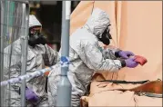  ?? CHRISTOPHE­R FURLONG / GETTY IMAGES ?? Forensic teams work at an address in Gillingham, Dorset as they remove a recovery truck used following the Salisbury nerve agent attack. British Prime Minister Theresa May is expected to announce a series of measures against Russia.