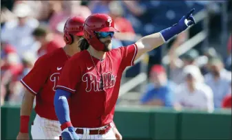  ?? CARLOS OSORIO — THE ASSOCIATED PRESS ?? The Phillies’ Bryce Harper waves to fans after his two-run home run during the fourth inning against the Pirates on Wednesday in Clearwater, Fla.