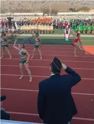  ?? RECORDER PHOTO BY ESTHER AVILA ?? 2021 Veterans Day Parade Grand Marshal Brian Stanley Adams salutes as 70 majorettes and twirlers perform to “Anchors Aweigh” at the 2021 Buck Shaffer Band-a-rama held Thursday at Jacob Rankin Stadium.