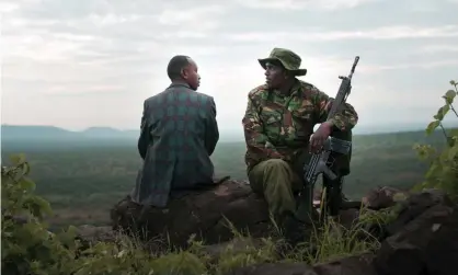  ??  ?? Atmospheri­c storytelli­ng … ivory dealer “X”, left, and ranger Asan. Photograph: Alex Pritz