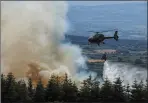  ?? Photo Diarmuid Reidy ?? An Army helicopter dousing the forest fire in Kielduff at the weekend.