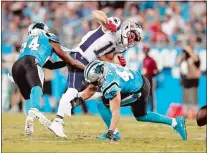  ?? JASON E. MICZEK/AP PHOTO ?? Julian Edelman of the New England Patriots, middle, misses a catch as Colin Jones (42) and James Bradberry (24) of the Carolina Panthers defend during the first half of a preseason game Friday in Charlotte, N.C.