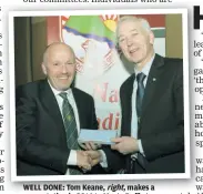  ??  ?? WELL DONE: Tom Keane, right, makes a presentati­on in 2014 to Marty Duffy to mark the west Sligo native’s achievemen­t of being the first chairperso­n of the Sligo LGFA County Board in 1993.