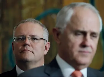  ??  ?? Scott Morrison and Malcolm Turnbull. © Alex Ellinghaus­en / Fairfax Media