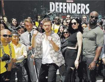  ?? Eric Charbonnea­u ?? Finn Jones, Krysten Ritter, Mike Colter and Charlie Cox meet fans at The Netflix Experience at Comic-Con in San Diego.