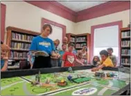  ??  ?? Team Goofball’s Robbi Davis, 11, left, and Sullivan Krol, 10, take part in the Oneida Public Library’s Lego robotics summer camp on Friday, Aug. 24, 2018.