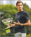  ?? Associated Press photo ?? Switzerlan­d's Roger Federer walks with the Norman Brookes Challenge Cup after winning the men's singles final at the Australian Open against Croatia's Marin Cilic in Melbourne, Australia, Monday.