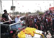  ?? ANI ?? Prime Minister Narendra Modi waves to the people on his way from Gandhinaga­r to Raksha Shakti University, on Saturday.