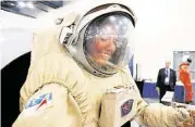  ??  ?? Monica Luna tries out a Sokol spacesuit during the Space Commerce Conference and Exposition.