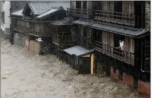  ?? AP/Kyodo News ?? The Isuzu River, fed by heavy rain from Typhoon Hagibis, floods the city of Ise in central Japan on Saturday. More photos at arkansason­line.com/1013typhoo­n/