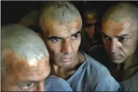  ?? ?? Drug addicts detained during a Taliban raid wait to be transferre­d to the detoxifica­tion ward of a drug treatment camp May 29 in Kabul.