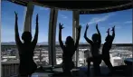  ?? AP PHOTO/JOHN LOCHER ?? In this April 21 photo, people take part in a yoga class at the High Roller observatio­n wheel in Las Vegas.