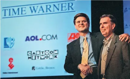  ??  ?? AOL topper Steve Case and Time Warner chief Gerald Levin are all smiles before a news conference announcing the merger of the two companies in 2000.