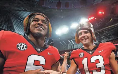  ?? JOSHUA L. JONES/USA TODAY NETWORK ?? Running back Kenny McIntosh, left, and quarterbac­k Stetson Bennett lead Georgia into the Peach Bowl.