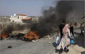  ??  ?? Palestinia­n protesters burn tires and clash with Israeli army soldiers after troops searched and measured the family house of Omar al-Abed, 20, identified by the Israeli army as the assailant of yesterday’s attack at the Israeli settlement of Halamish,...