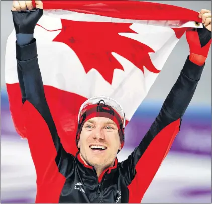  ?? AP PHOTO/VADIM GHIRDA ?? Gold medallist Ted-jan Bloemen of Canada celebrates with the national flag after the men’s 10,000-metre speedskati­ng race at the Gangneung Oval at the 2018 Winter Olympics in Gangneung, South Korea, Thursday.