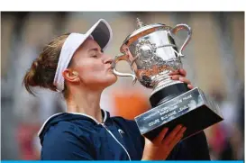  ?? AFP ?? PARIS: Czech Republic’s Barbora Krejcikova kisses and celebrates with the Suzanne Lenglen Cup after winning the women’s singles final match against Russia’s Anastasia Pavlyuchen­kova during the trophy ceremony of The Roland Garros 2021 French Open tennis tournament yesterday. —