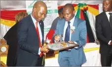  ??  ?? Dr Tinashe Manzungu of the ZNCC Midlands Chapter hands over the Best Financial Services award to Mr Gerald Zhou (left) of Inclusive Financial Services at the ZNCC Midlands Chapter Business Awards ceremony in Gweru last Friday