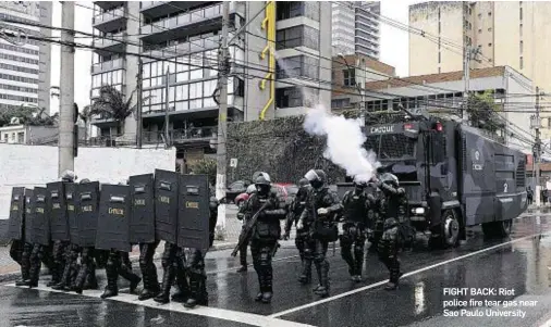  ??  ?? FIGHT BACK: Riot police fire tear gas near Sao Paulo University