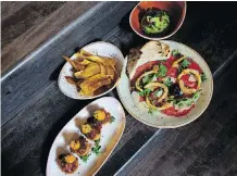  ??  ?? Guacamole with pomegranat­e, rib-eye carpaccio, crunchy rice cakes with tuna tartare, and plantain chips are served up at The Wednesday Room.