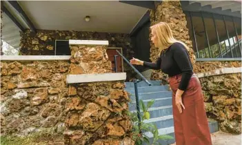  ?? TAMPA BAY TIMES PHOTOS ?? Lane Mari, vice president GM Constructi­on, shows the exterior Jan. 18, of a historic home made of stones dredged from the Hillsborou­gh River in Tampa more than a century ago.