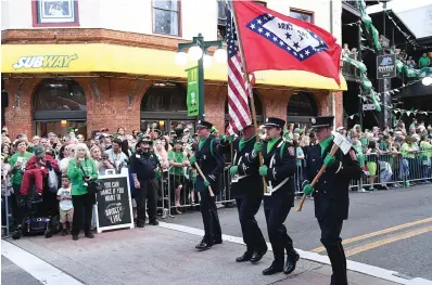  ?? The Sentinel-Record/File photo ?? ■ The Hot Springs Fire Department color guard crosses Bridge Street on March 17, 2022, at the start of the First Ever 19th Annual World’s Shortest St. Patrick’s Day Parade.
