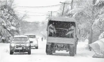  ??  ?? A National Guard vehicle carrying rescue divers as a massive winter storm bears down on the region in Scituate, Massachuse­tts. — AFP photo