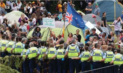  ?? Photograph: Marty Melville/AFP/Getty Images ?? Police and protesters outside parliament in Wellington.