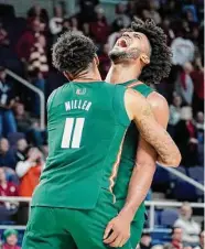  ?? John Minchillo/Associated Press ?? Miami’s Norchad Omier, right, and Jordan Miller did a lot of heavy lifting in Sunday’s victory over Indiana.