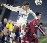  ?? Fred Jewell / Associated Press archive ?? Cobi Jones, left, and Carlos Bocanegra face off in a 2001 game. Both have been named to the MLS 25 Greatest list.