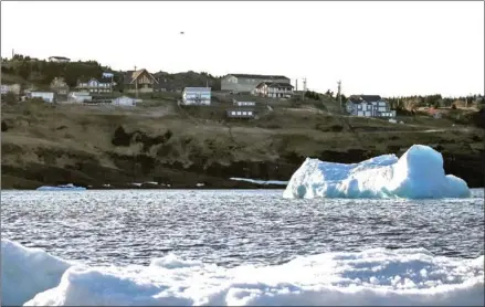  ?? DREW ANGERER/GETTY IMAGES/AFP ?? An iceberg floats in Flatrock Cove in Flatrock, Canada. Billions of tonnes of meltwater flowing into the world’s oceans from the Greenland and Antarctic ice sheets could boost extreme weather, researcher­s have said.